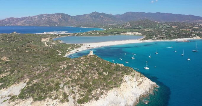 Aerial view of Spiaggia di Porto Giunco, a beautiful bay near a 17th century watchtower, The Aragonese Tower of Porto Giunco, in Sardinia, Italy