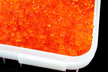 Red caviar in a large tray. Wholesale and retail trade in seafood. Close-up
