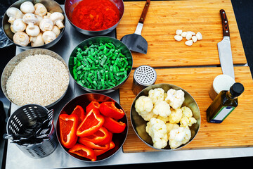 The process of preparing healthy food from vegetables and rice, as well as mushrooms and sweet peppers. Close-up. selective focus