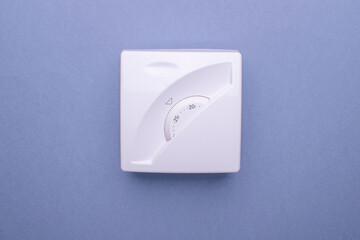 White thermostat showing the temperature in celsius in the house. The concept of saving gas and electricity.