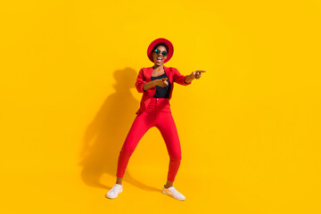 Fototapeta na wymiar Photo of attractive funky short hair human wear formal outfit cap eyewear dancing pointing empty space isolated yellow color background