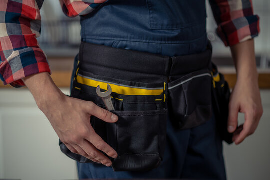 Serviceman dressed in workwear standing in the workplace