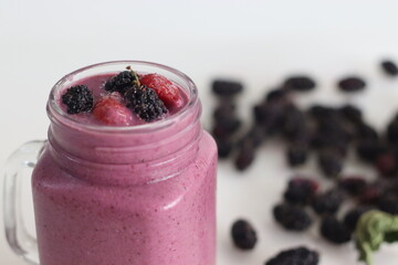 Mixed berry smoothie. Thick and creamy smoothie made of fresh strawberry and mulberry in almond...