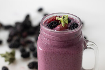 Mixed berry smoothie. Thick and creamy smoothie made of fresh strawberry and mulberry in almond milk. Served in smoothie jar
