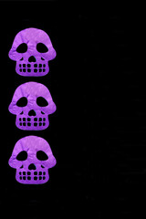 Colored papel picado for an offering for the Mexican tradition of the Day of the Dead and All Saints with skull shapes on a black background