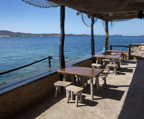 Fototapeta na wymiar coast, sea, terrace, table stools, sant antoni, , ibiza, spain, balearic Islands, Mediterranean Sea,