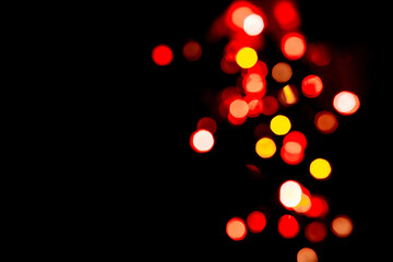 Festive background with colorful bokeh on black background, copy background