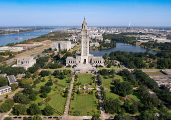 Baton Rouge State Capitol Louisiana city Old Mississippi River bridge levee tug boats and chemical plant mid angle afternoon