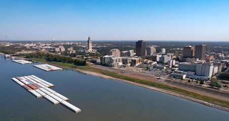 Baton Rouge State Capitol Louisiana city Mississippi River levee tug boats mid angle afternoon