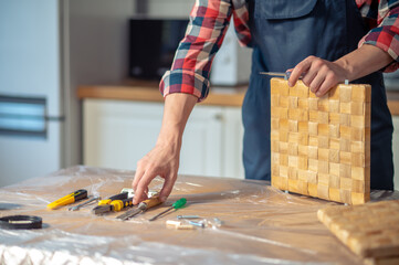 Experienced woodworker choosing a carpentry tool for work