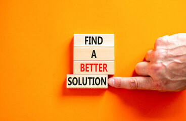 Find a better solution symbol. Concept words Find a better solution on wooden blocks. Beautiful orange table orange background. Businessman hand. Business find a better solution concept. Copy space.
