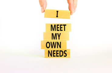 I meet my own needs symbol. Concept words I meet my own needs on wooden blocks. Businessman hand. Beautiful white table white background. Business and i meet my own needs concept. Copy space.