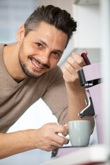 a man prepares espresso for a coffee maker