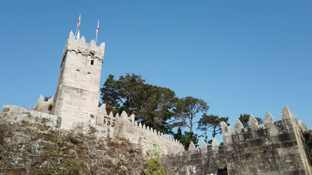 DOLLY SHOT - The Fortified Clock Tower next to the Royal Gate of the Historical Castle of Monterreal on the Monte Boi peninsula in the Galician village of Baiona, Spain. 