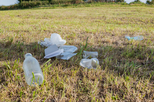 Plastic trash left on grassy ground