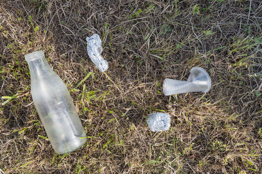 Plastic trash left on grassy ground