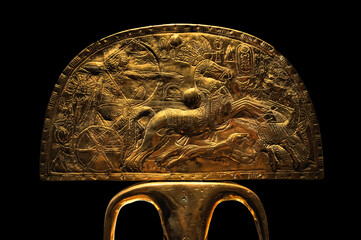 golden artifact from Egypt with chariot rider