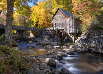 Glade Creek Grist Mill in Babcock State Park in West Virginia, It is autumn and the trees are colorful. The creek in front of the mill is flowing. Long exposure with nobody in the image