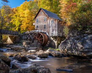 Glade Creek Grist Mill in Babcock State Park in West Virginia, It is autumn and the trees are colorful. The creek in front of the mill is flowing. Long exposure with nobody in the image