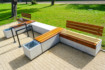 New modern design outdoor infrastructure object, wooden plank rest benches with a concrete base - obrazy, fototapety, plakaty