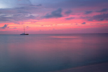 Aruba idyllic caribbean beach with boats at sunset, Dutch Antilles Sea