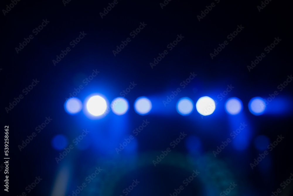 Wall mural stage lighting. spotlights with colored lights on a stage. artificial lighting. black background and