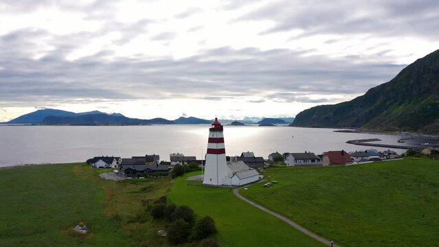Flying above the iconic Alnes Lighthouse on a cloudy day, Aerial Orbit