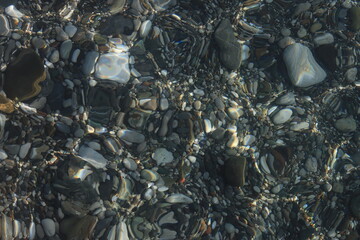 Stones in clear sea water as a texture background image