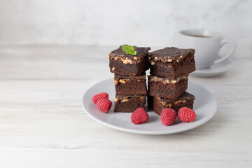 Chocolate nut brownie cake decorated with raspberries.