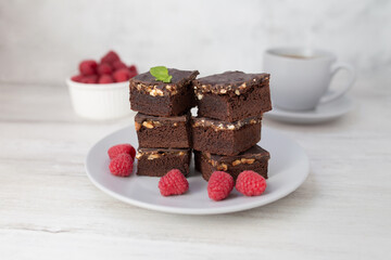 Chocolate nut brownie cake decorated with raspberries.