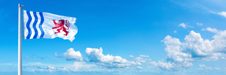 Nouvelle-Aquitaine, France - flag waving on a blue sky in beautiful clouds - Horizontal banner
