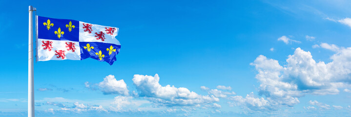 Picardy, France - flag waving on a blue sky in beautiful clouds - Horizontal banner