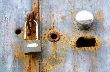 Old rusty iron door and padlock.