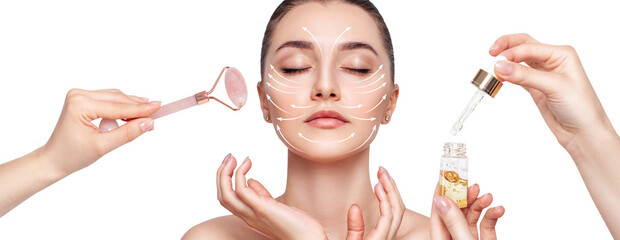 Young woman using pink quartz Gua Sha roller for face with serum.