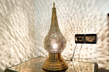 Metal Arab lamp sitting on the bedside table