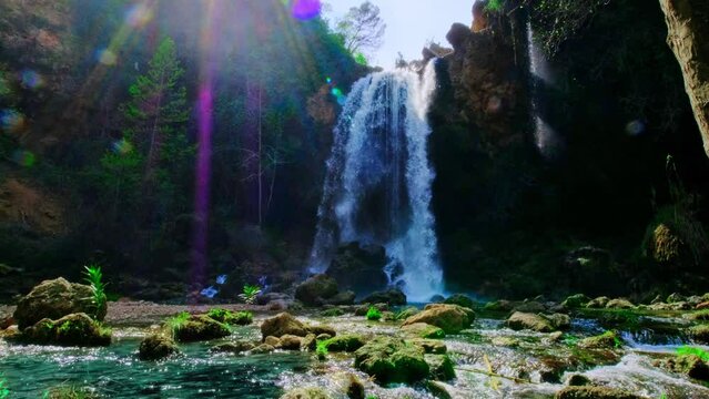 Beautiful large waterfall. Sunbeams and lens flare. 