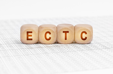 On the table with documents are wooden cubes with the inscription - ECTC