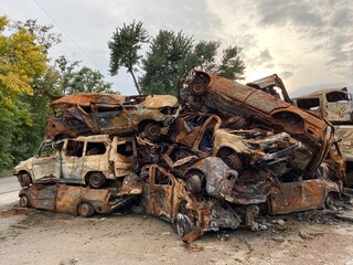 Fototapeta na wymiar A bunch of burned and shelled cars in Hostomel in the Kyiv region