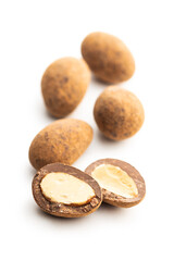 Almonds in chocolate coated in cocoa powder isolated on white background.