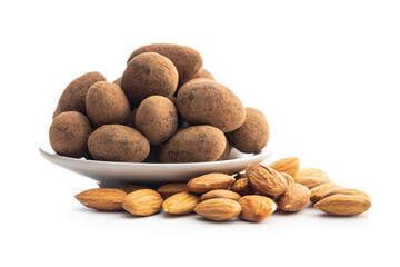 Almonds in chocolate coated in cocoa on plate isolated on white background.