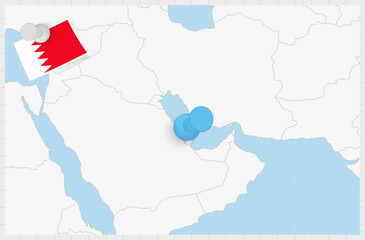 Map of Bahrain with a pinned blue pin. Pinned flag of Bahrain.