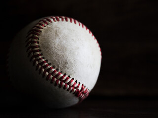 Baseball photographed in natural light with a dark background
