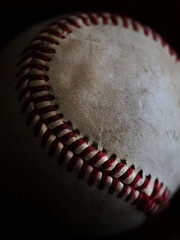 Baseball photographed in natural light with a dark background