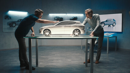 Experienced car designers and developers discuss the design and shape of the prototype model car...