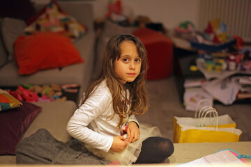 Young girl 6-7 years old looks straight ahead