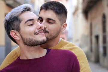Happy gay men couple having tender moment outdoor - Focus on left man face