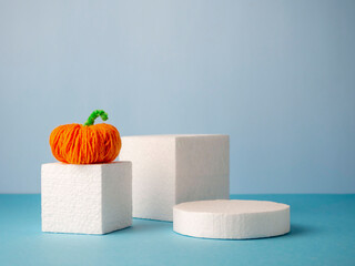 Funny string pumpkins on podiums in rectangular shapes on a blue background.