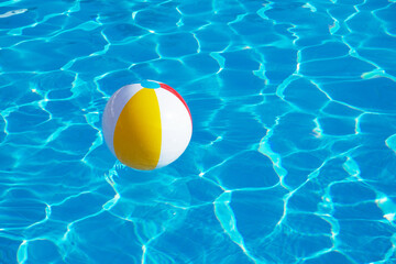 Colorful inflatable ball floating in swimming pool