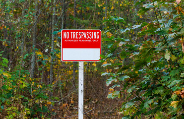 No trespassing warning sign along road