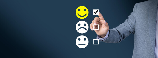 A businessman clicks on a smiley for quality evaluation